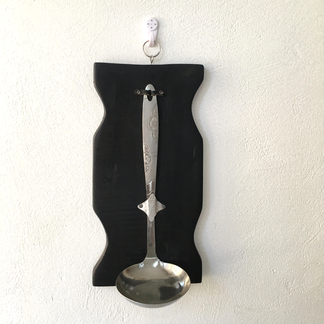 Uniquely curated candle stands with a repurposed serving spoon