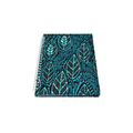 Notebook with blue leaf pattern on a white background